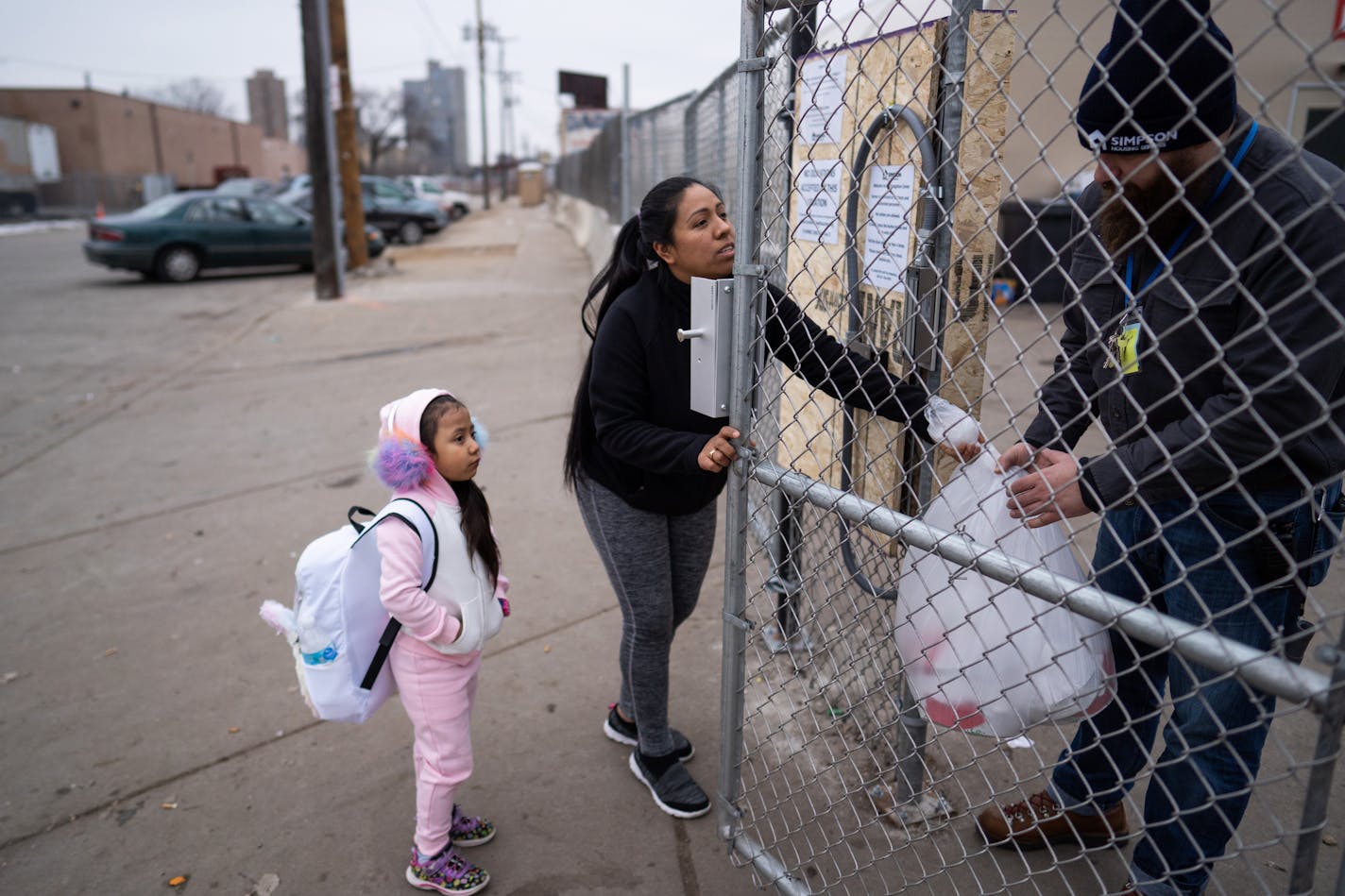 Maribel Cruz and her four-year-old daughter Bella delivered meals of chicken and rice they purchased from Cub to the navigation center. Cruz said she wanted to set an example for her daughter.