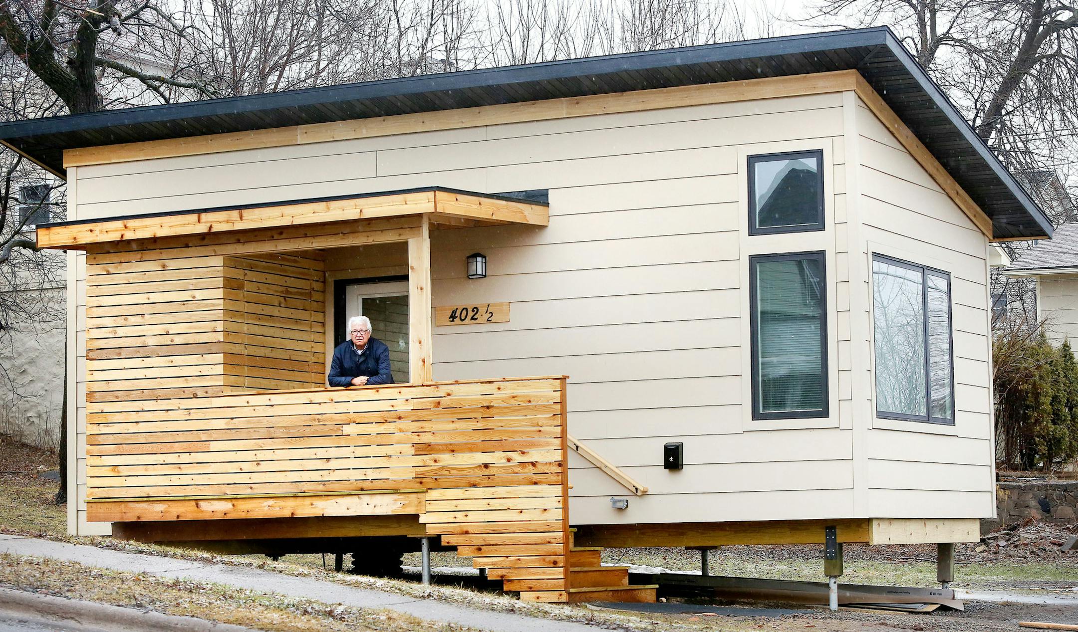 Rick Klun, executive director of Center City Housing, stands at the entryway to the new micro-house, a 300-square-foot home, at 402 1/2 E. Seventh St.