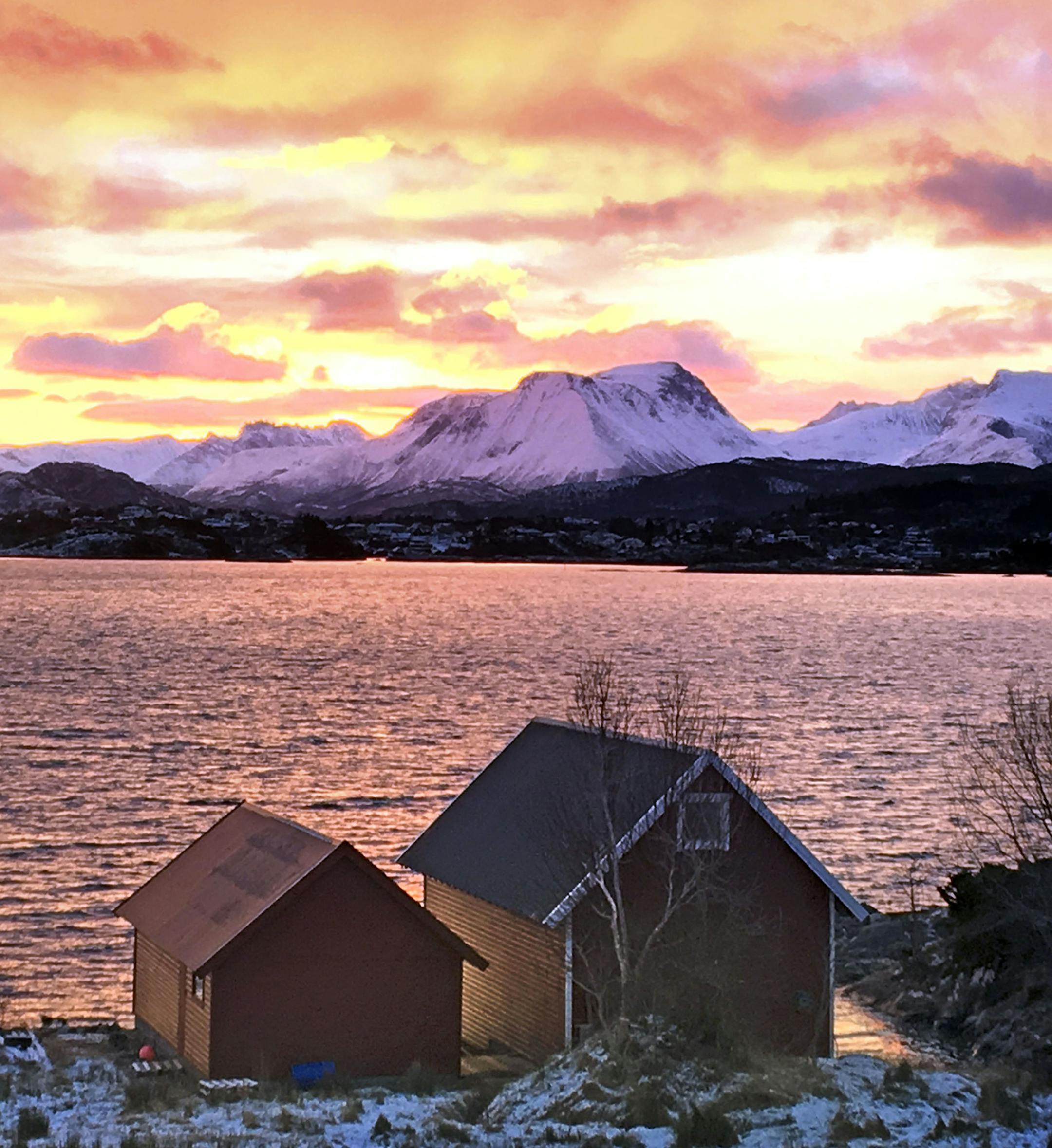 Can I have your name as you would like it to appear in print, and the town in which you live? Mark H. Weber ñ Eden Prairie, MN Where were you when you took this photo? What does it show? While traveling with my wife Cynthia on a trip to visit our 250 year old family farm in Norway in February, we took a morning walk along the Hjorundfjord just outside of Alesund, Norway. The morning sunrise over the Sunnomore Alps mountain range provided a panoramic backdrop to ancient boathouses in traditi