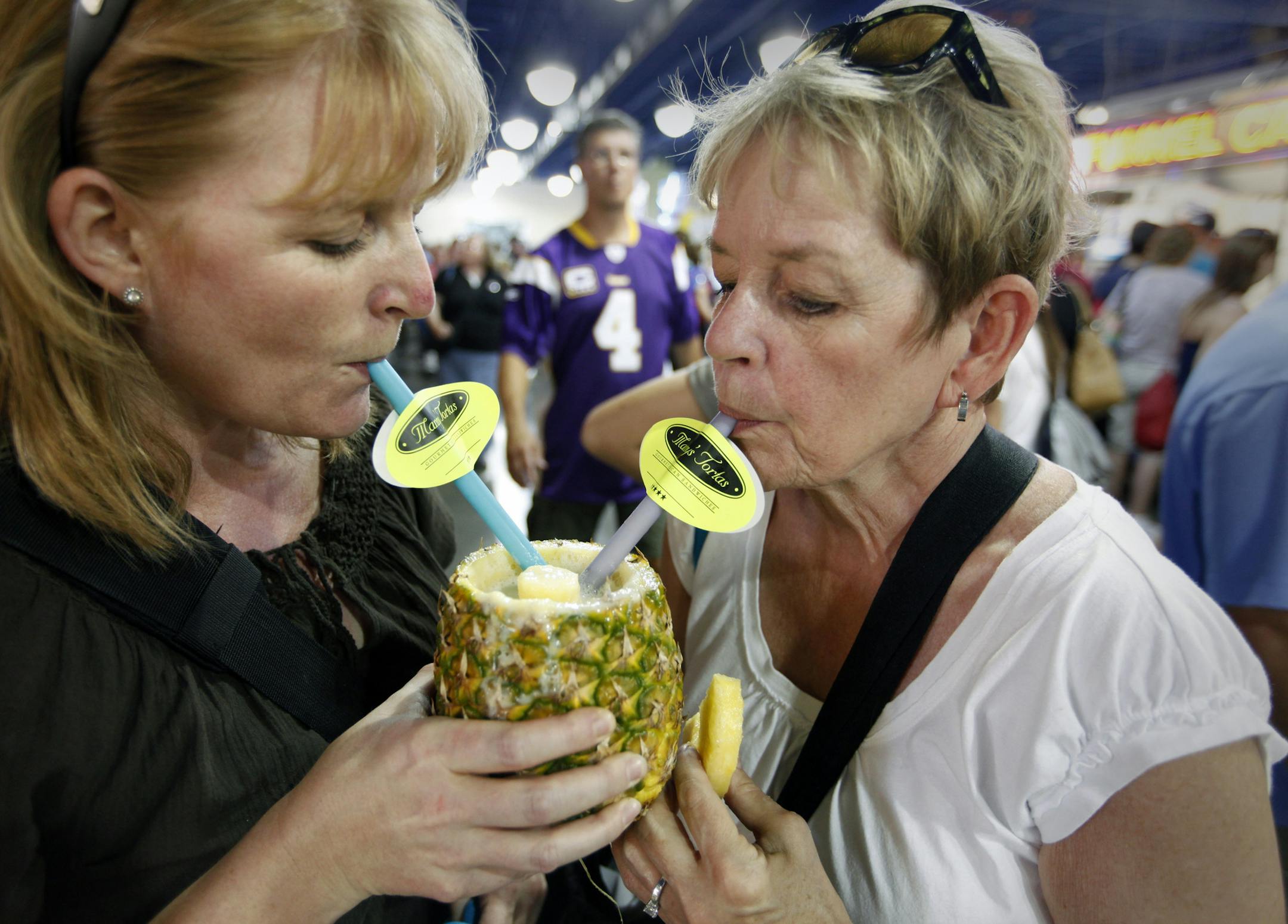 TOM WALLACE • twallace@startribune.com Assignment #20013789A Slug: newfairfood082710 Date: august 26th, _Choices by Rick Nelson on new additions to the food lists to try at the Minnesota State Fair. THIS PHOTO: ] Pina Coladas at Manny's Tortas are enjoys by 30year fair fans. left Gretchen Vrieze and her Mom Joan Vrieze have made the fair a special day by going together by themselves for the last tewnty years.
