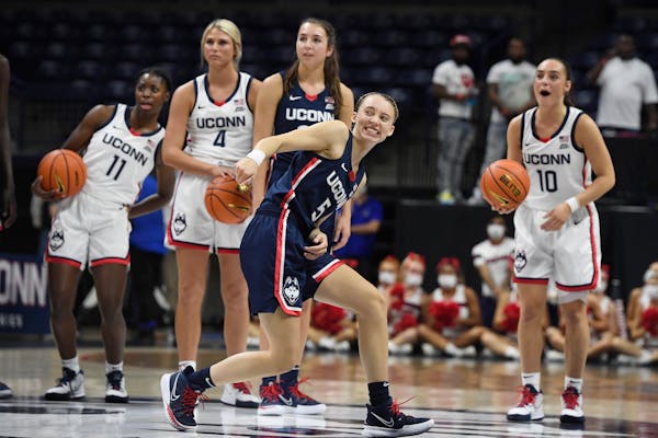 Connecticut’s Paige Bueckers took a shot from half-court during First Night events for the UConn men’s and women’s NCAA college basketball teams