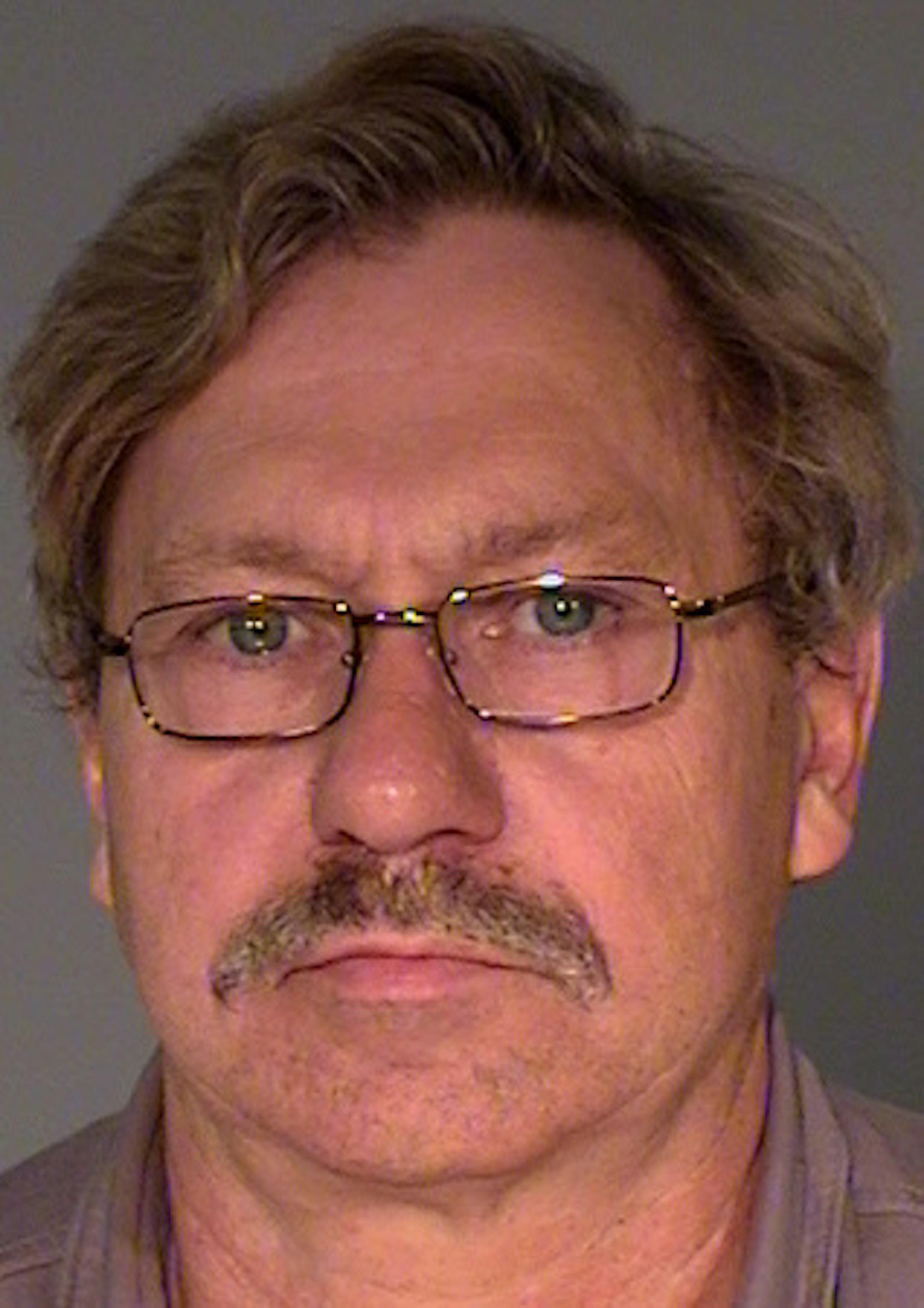 Walter J. Happel, 62, is charged with peeking underneath a bathroom stall at a student in St. Paul.
