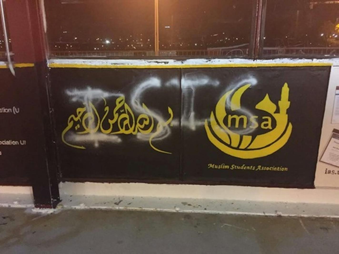 ISIS is spray-painted on the Muslim Students Association sign on the University of Minnesota's Washington Avenue Bridge.