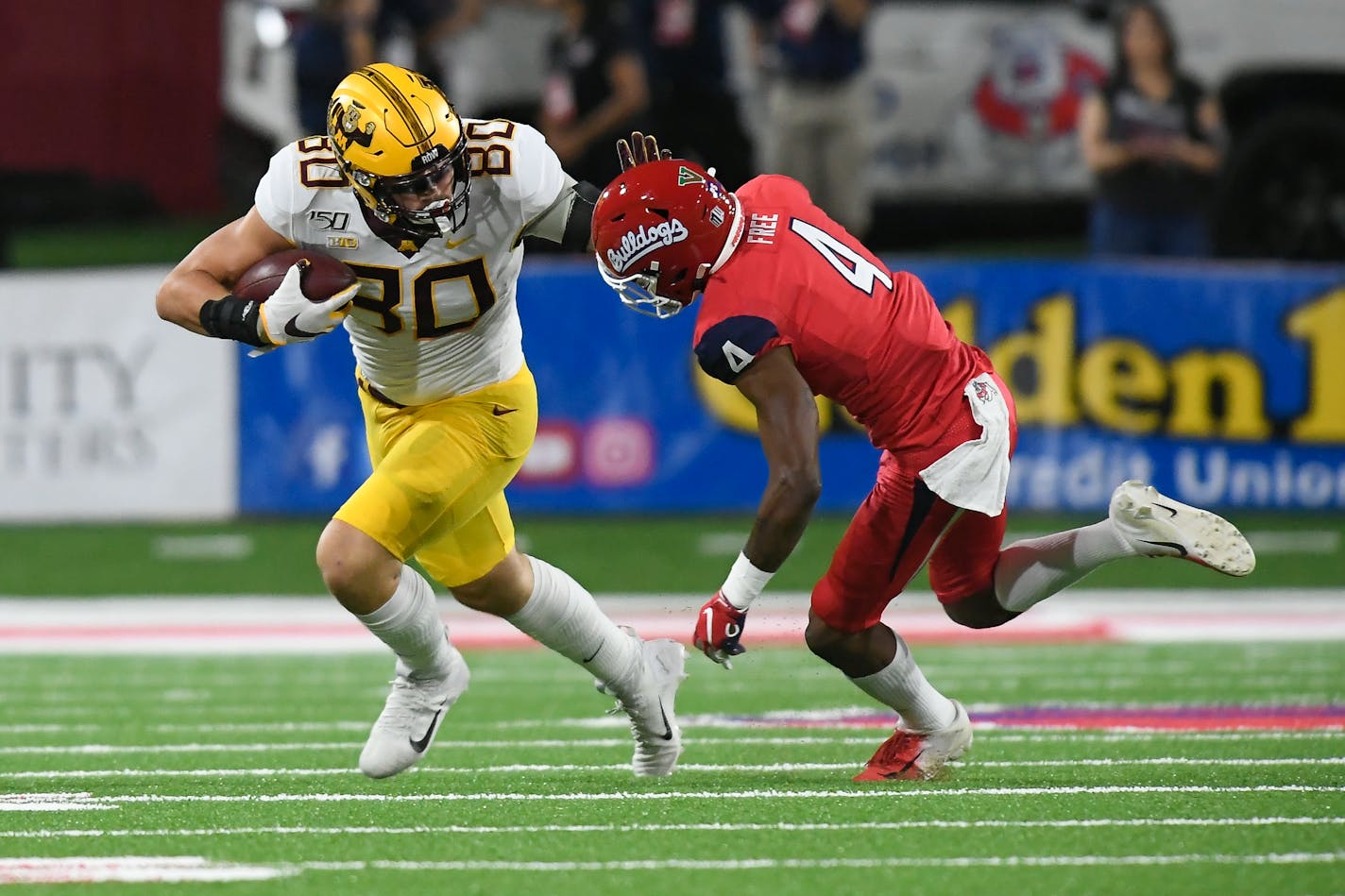 Gophers tight end Jake Paulson ran the ball against the defense of Fresno State defensive back Wylan Free