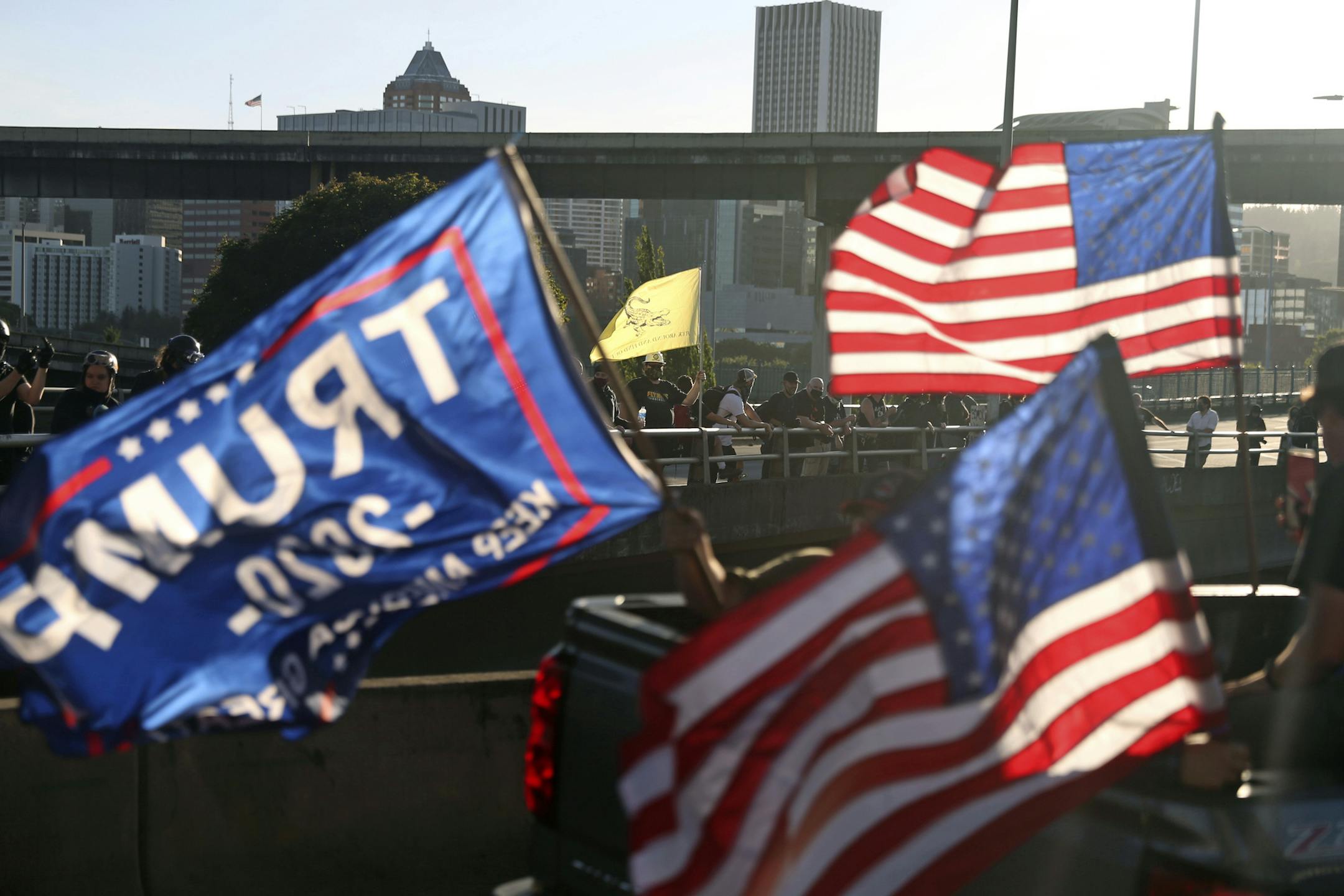 A caravan of supporters of President Donald Trump drive in downtown Portland, Ore., Saturday, Aug. 29, 2020. Saturday's rally was the third consecutive weekend that pro-Trump demonstrators converged in and around Portland, leading to clashes with counter protesters. (Dave Killen/The Oregonian via AP)