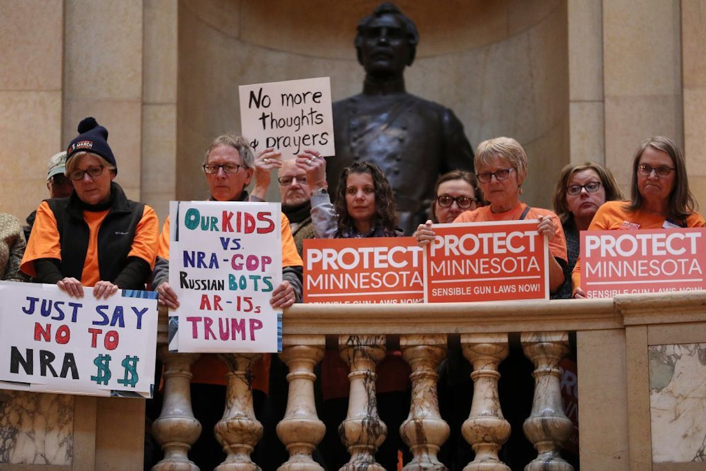 Advocates held signs as they packed all three floors of the State Capitol rotunda during a rally calling for sensible gun laws sponsored by Protect Minnesota.