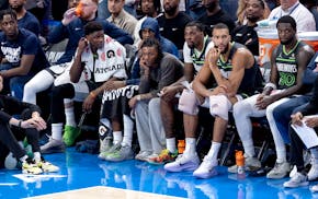 Minnesota Timberwolves starters watch from the bench late in the fourth quarter during Game 1 of the Western Conference finals against the Oklahoma Ci
