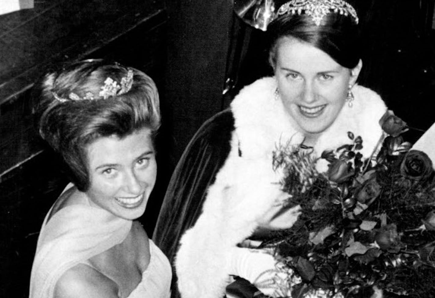 On Oct. 23, 1963, Homecoming Queen Judy King (right) received a bouquet from the University of Minnesota&#x2019;s 1962 queen, Andrea Hericko.