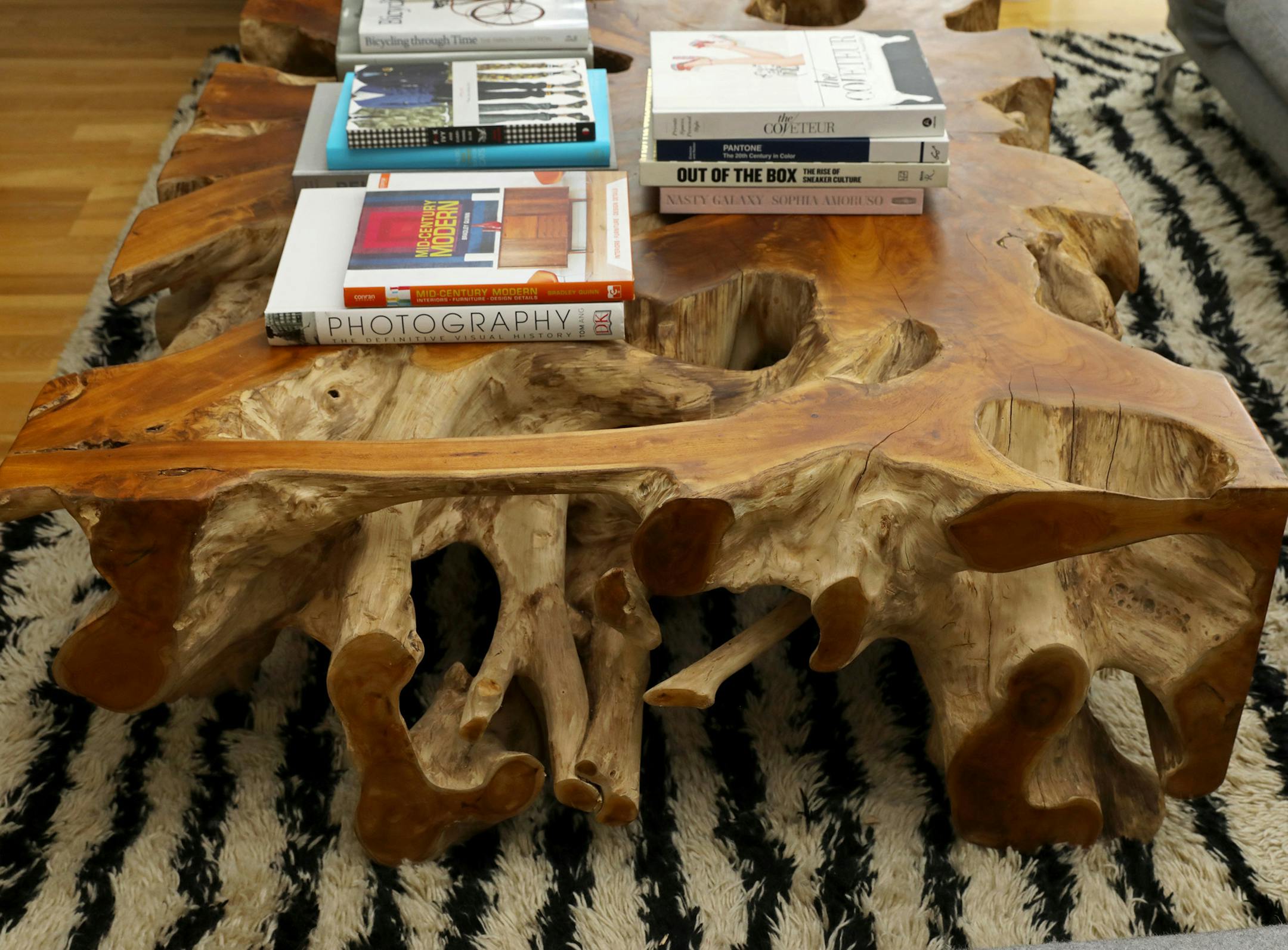 It took a lot of work to bring in this teak root coffee table, says homeowner Max Lemman, but now that it's secure on a black-and-white striped shag rug, it's a hit with everyone. "It's superfun," says interior designer Barbara Hyde Evans. "The first second we installed it, a cat was playing in it." (Ken Lambert/The Seattle Times/TNS)