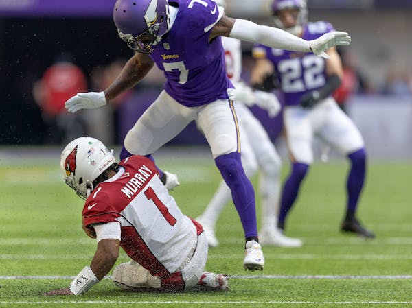 Cardinals quarterback Kyler Murray (1) slid under Vikings cornerback Patrick Peterson (7) during the third quarter .