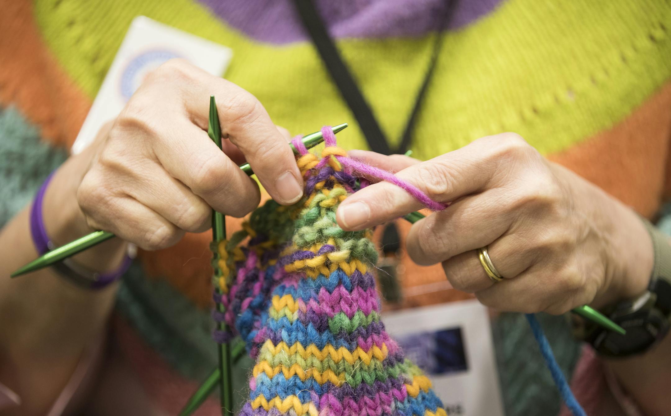 Kay Crowthers of the MN Knitter's Guild works on a pair of mittens during Vogue Knitting Live. ] (Leila Navidi/Star Tribune) leila.navidi@startribune.com BACKGROUND INFORMATION: The Vogue Knitting Live conference at the Minneapolis Convention Center on Sunday, November 6, 2016. The event features an opening yarn drop, boutique marketplace, workshops, a runway fashion show and yoga for knitters.