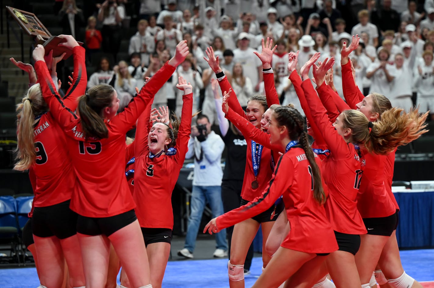 Mayer Lutheran celebrates with their trophy after their victory in the Class 1A volleyball state tournament championship match Saturday, Nov. 13, 2021 at the Xcel Energy Center in St. Paul, Minn. Mayer Lutheran defeated Minneota 3-0. ] AARON LAVINSKY • aaron.lavinsky@startribune.com