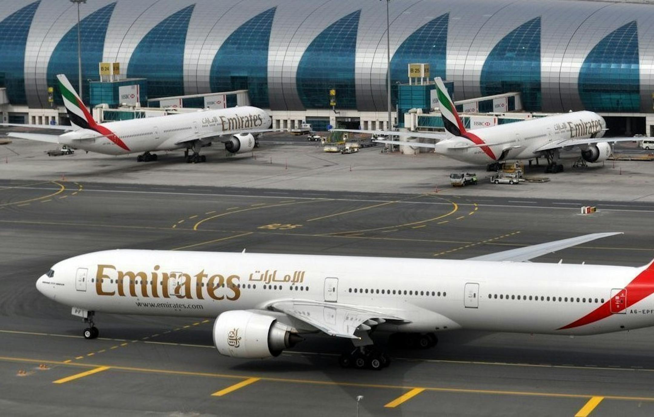 An Emirates plane taxis to a gate at Dubai International Airport at Dubai International Airport in Dubai, United Arab Emirates, on Wednesday, March 22, 2017. The president of the Middle East's biggest airline says a ban on electronics other than mobile phones in the cabins of U.S.-bound flights came as a complete surprise as he defended security measures at its Dubai hub. (AP Photo/Adam Schreck) ORG XMIT: CAIMA103