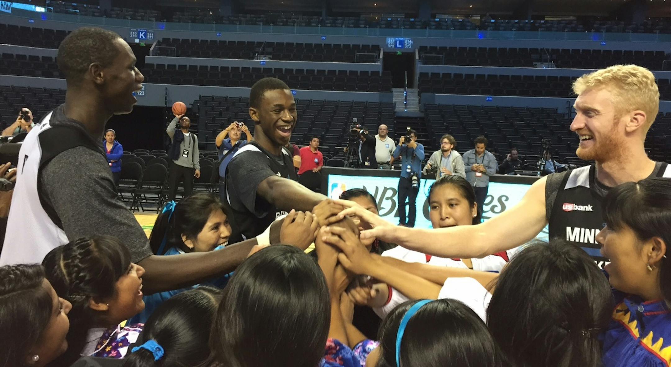 Wolves players Gorgui Dieng, Andrew Wiggins and Chase Budinger, from left, had some fun Tuesday at a youth clinic after practice in Mexico City.
