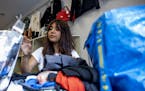 Associate Manager of secondhand apparel store Crossroads Trading, Wendy Garfias, 22, buys and trades clothing from costumers in Chicago's Wicker Park 