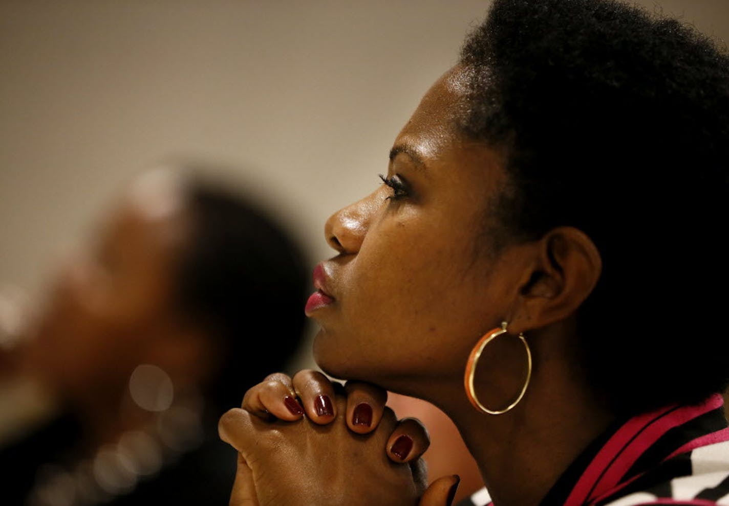 Sondra Samuels President/CEO of Northside Achievement Zone listened as Former Congresswoman Gabrielle Giffords joined Minneapolis Chief Janee Harteau and other local women leaders and domestic violence prevention advocates for a roundtable discussion need for laws the protect women and families form gun violence at the Harriett Tubman Center Monday October 20 , 2014 in Minneapolis ,MN. ] Jerry Holt Jerry.holt@startribune.com