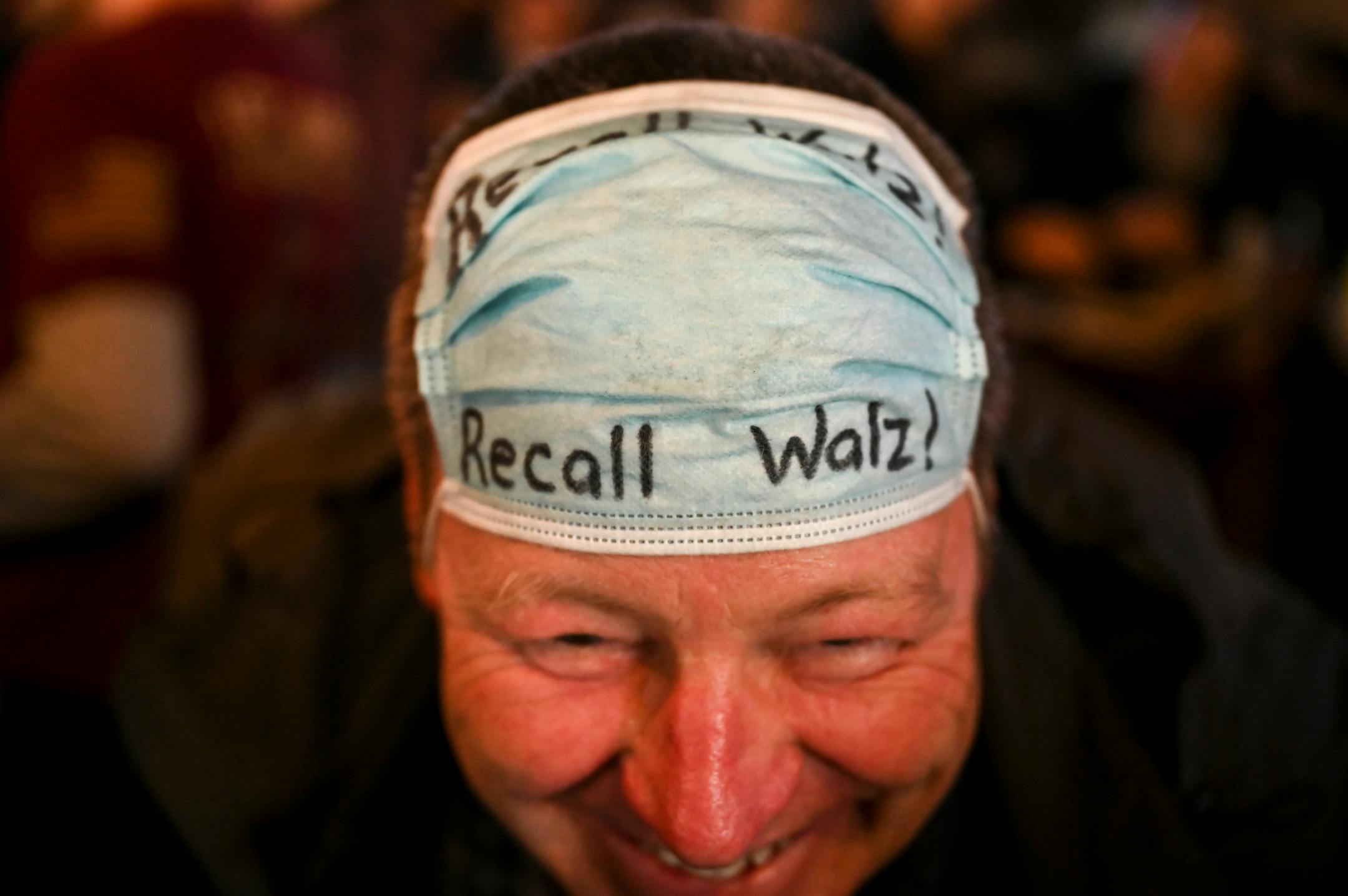 Dean Wedul, of Lakeville, wore a surgical mask with Recall Walz written on it while patronizing Alibi Drinkery in Lakeville on Wednesday.