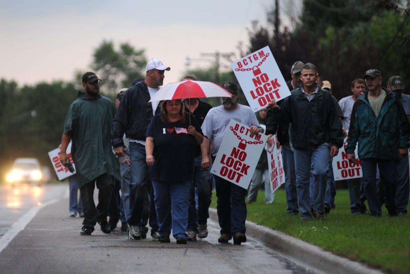 Employees walked down the road with picket signs during the first day of a lock-out August 1, 2011 outside of the sugar beet plant in Moorhead.