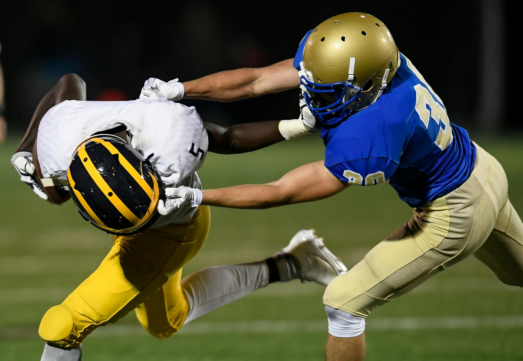 Wayzata defensive back David Sandall (30) grabbed the face mask of Rosemount running back Marvin Walker (5) during a tackle in the fourth quarter Thursday night. ] AARON LAVINSKY ï aaron.lavinsky@startribune.com Wayzata played Rosemount in a high school football game on Thursday, August 31, 2017 at Wayzata High School in Plymouth, Minn.