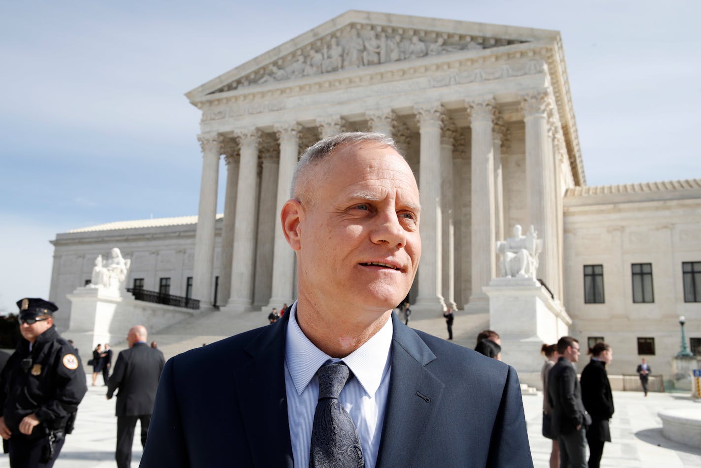 Andy Cilek stands outside of the Supreme Court, Wednesday, Feb. 28, 2018, in Washington, where a Minnesota law that bars residents from wearing political clothing at the polls -- from Donald Trump's "Make America Great Again" hats to Democratic Party T-shirts and union buttons -- is being debated at the Supreme Court.