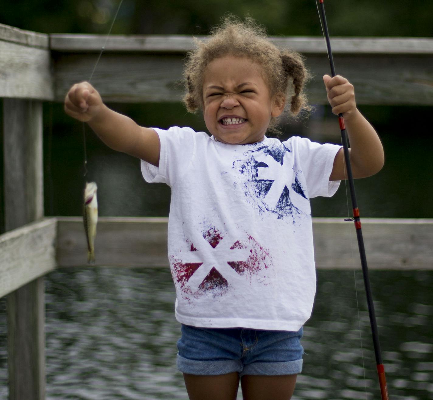 Siri Johnstone shows off the small fish she caught. ] ALEX KORMANN &#x2022; alex.kormann@startribune.com Each year as part of the Hopkins Raspberry Festival, dozens of children take to the banks and docks of Shady Oak Lake for a fishing frenzy. The Hopkins VFW provide every child in attendance with a free fishing rod and tub of bait, both of which the kids get to keep and take home with them. On Wednesday, July 11, 2018 the fish were really biting as kids pulled in scores of little sunnies and b