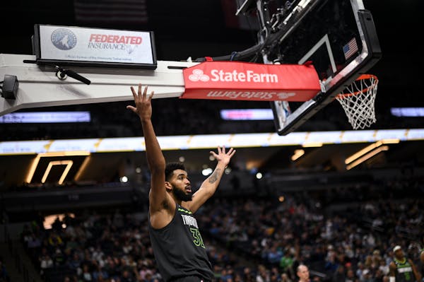 Minnesota Timberwolves center Karl-Anthony Towns (32) argues against a defensive foul call against the Houston Rockets during the second half Saturday