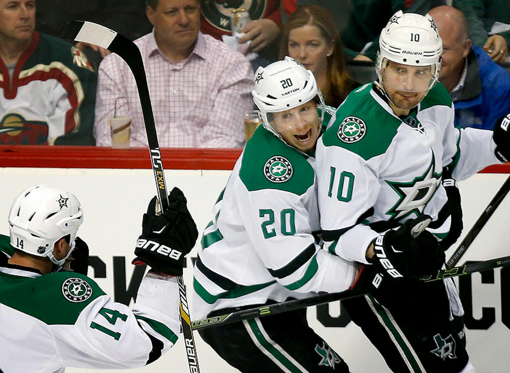 Jamie Benn (14), Cody Eakin (20) and Patrick Sharp (10) celebrated a goal by Sharp in the first period.