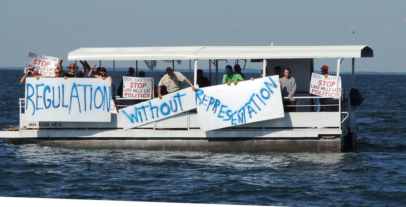 In this Saturday, July 8, 2017, photo provided by Mille Lacs Messenger, people on a boat encircle Minnesota Gov. Mark Dayton, not pictured, on Mille Lacs Lake to protest a temporary ban on walleye fishing in Minnesota. The Star Tribune reports that Dayton was with a group fishing for bass on the lake Saturday when dozens of protesters encircled him. (Vivian LaMoore/Mille Lacs Messenger via AP) ORG XMIT: MIN2017071018264931 ORG XMIT: MIN1707101834060775