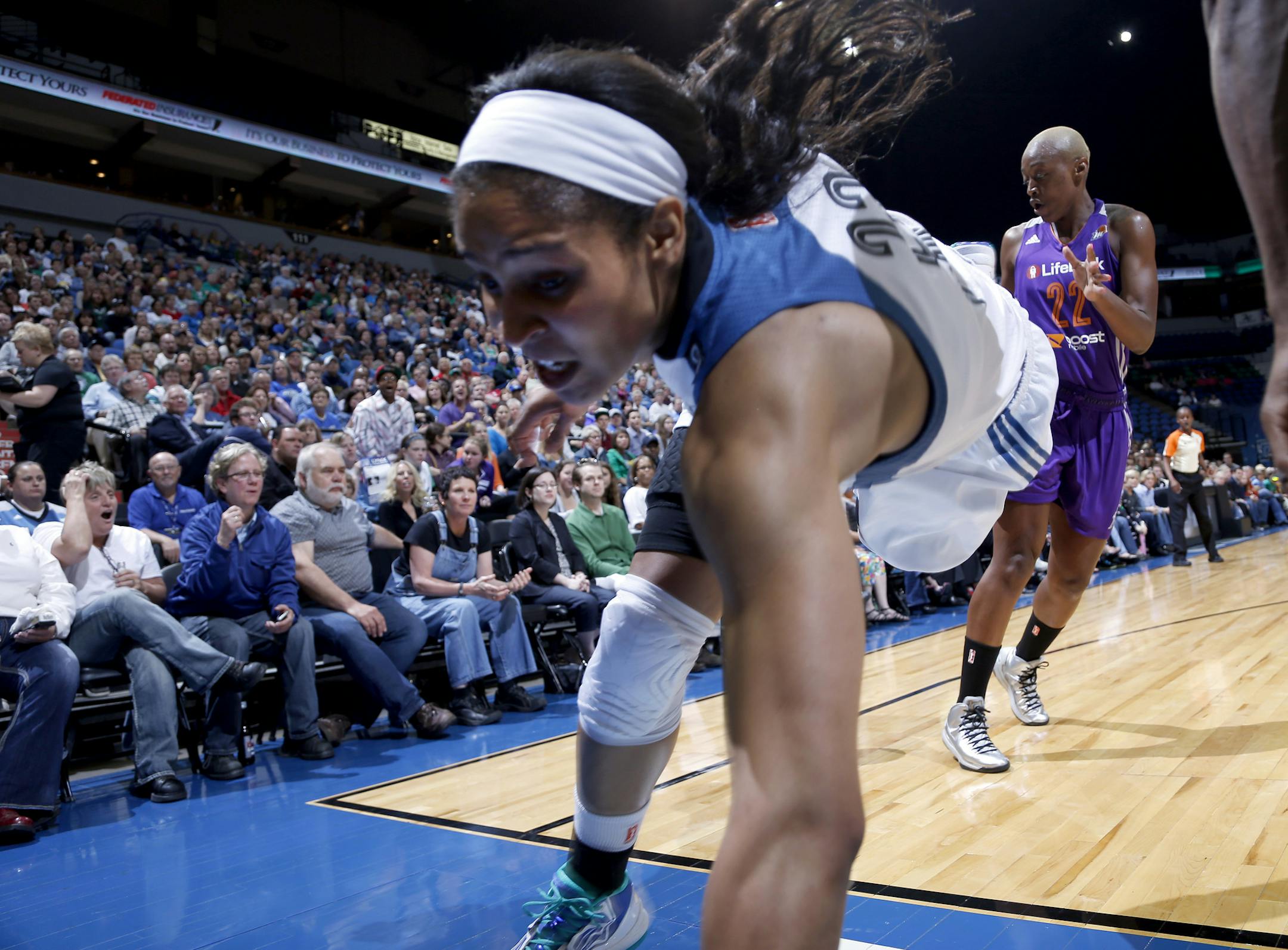 Maya Moore (23) fell out of bounds after chasing a loose ball with Charde Houston (22) in the second quarter. ] CARLOS GONZALEZ cgonzalez@startribune.com June 5, 2013, Minneapolis, Minn., Target Center, WNBA, Minnesota Lynx vs. Phoenix Mercury