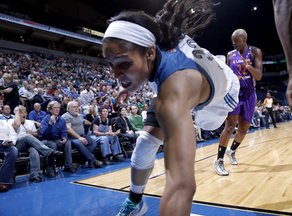Maya Moore (23) fell out of bounds after chasing a loose ball with Charde Houston (22) in the second quarter. ] CARLOS GONZALEZ cgonzalez@startribune.