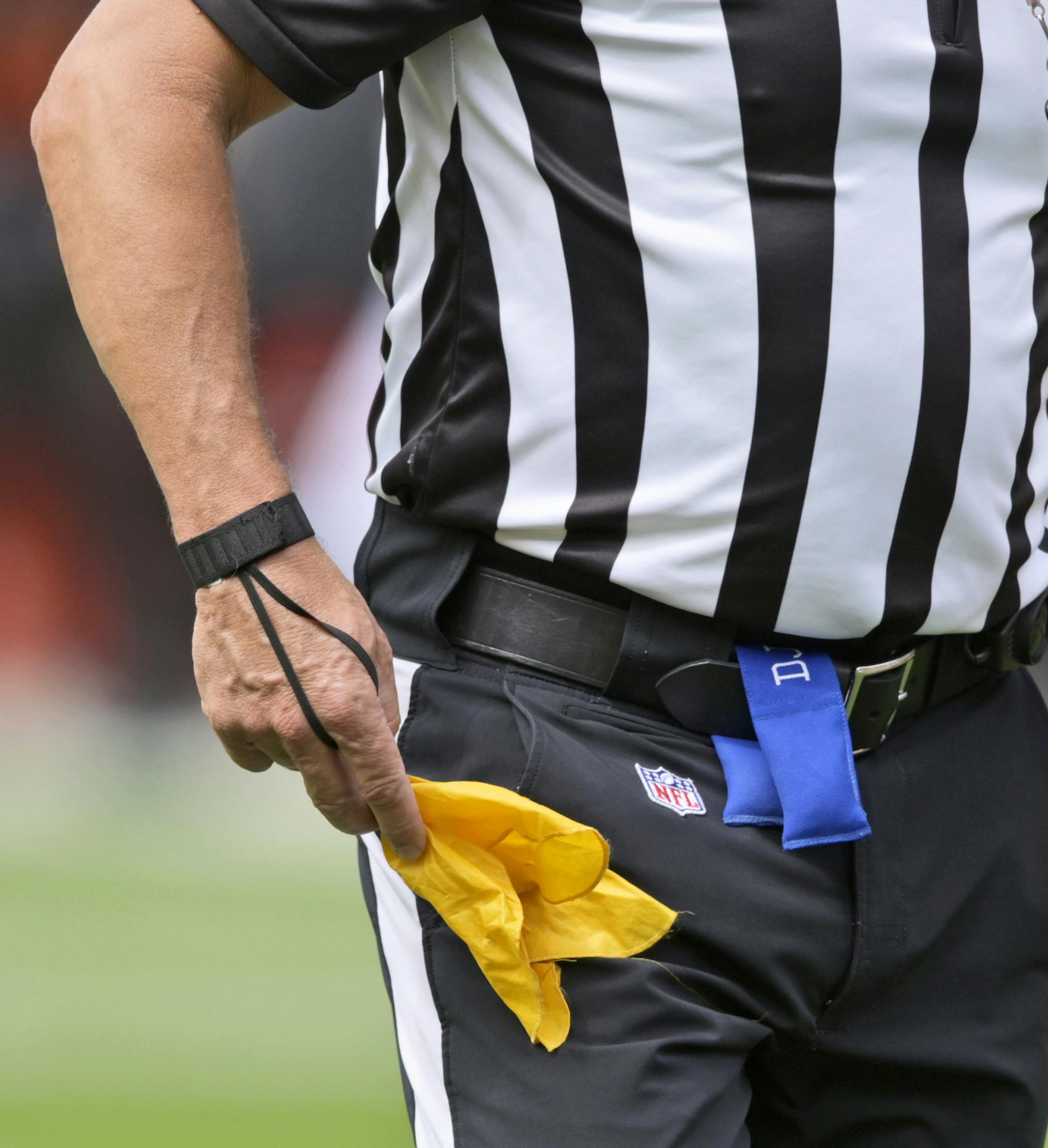 An NFL referee puts away his penalty flag after a penalty in the first half of an NFL football game between the Tennessee Titans and the Cleveland Browns, Sunday, Sept. 8, 2019, in Cleveland. (AP Photo/David Richard) ORG XMIT: NYOTK