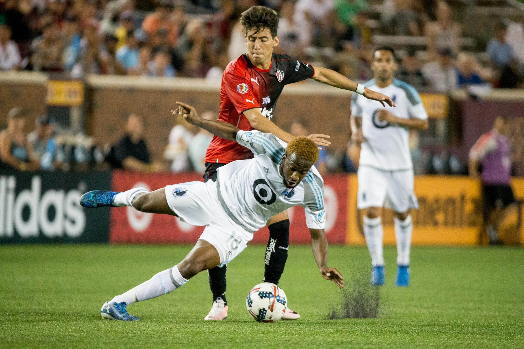 Minnesota United�s Kevin Molino and Atlas� Javier Salas fight for the ball during the second half on Saturday, July 15, 2017, at TCF Bank Stadium.