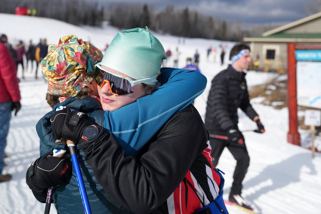 Duluth East senior Lydia Kraker gets a hug from her mom, Erin, after competing at the Nordic skiing state meet in Biwabik on Wednesday.