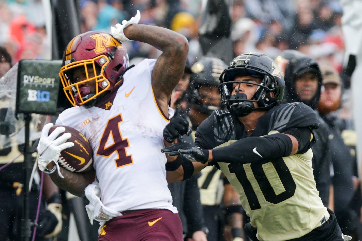 Purdue safety Cam Allen pushes Gophers running back Mar'Keise Irving out during the second quarter