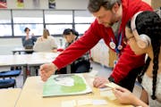 Visual arts teacher Kent Miller chats with Maya Reynolds, 18, during an AP art class on Feb. 29 at St. Paul's Open World Learning Community.
