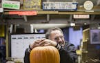 Owner Kevin Huebscher jokes with customers while weighing pumpkins at Kev's Korner in Inver Grove Heights on Friday, October 30, 2105. ] (LEILA NAVIDI