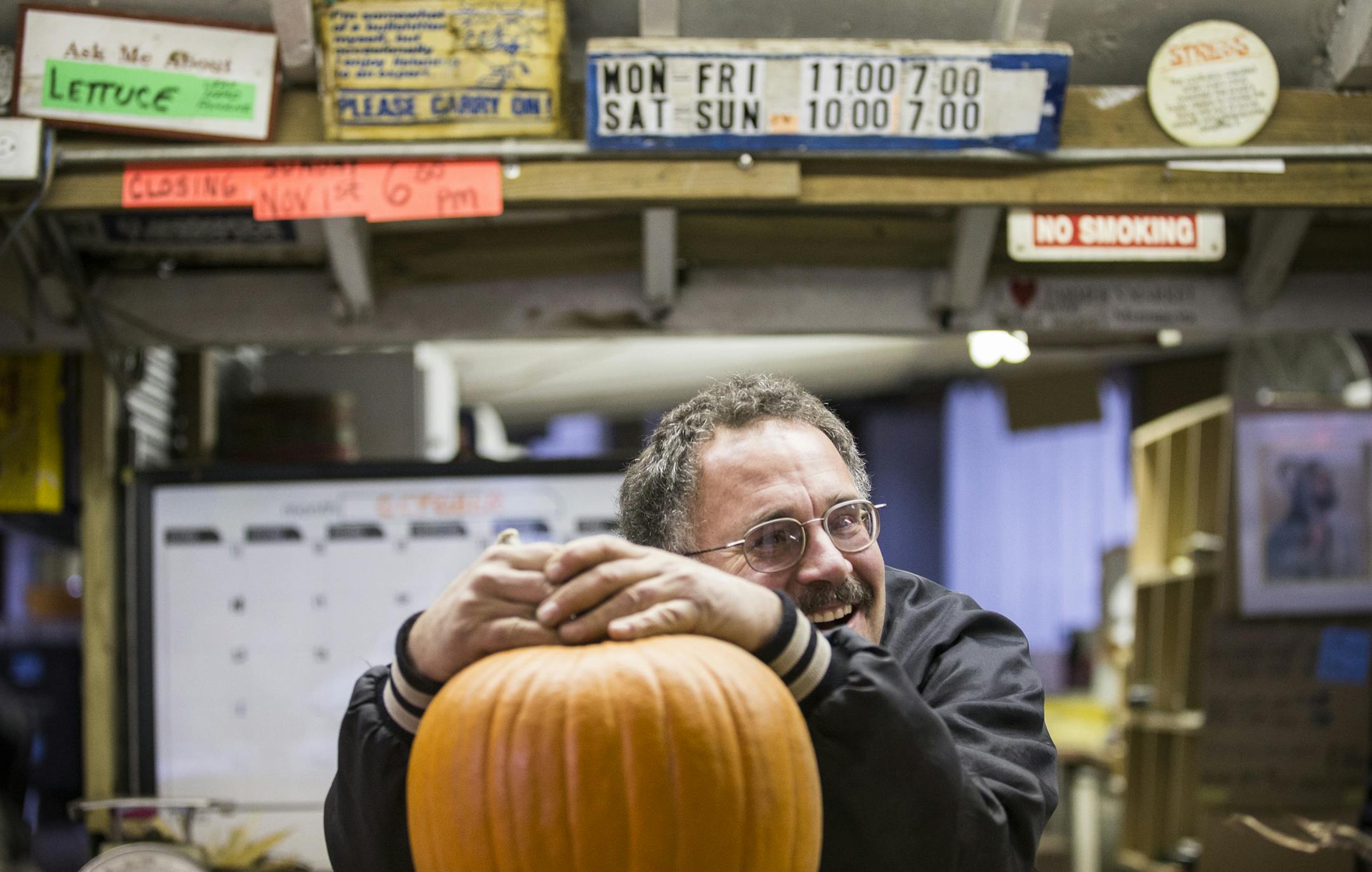 Owner Kevin Huebscher jokes with customers while weighing pumpkins at Kev's Korner in Inver Grove Heights on Friday, October 30, 2105. ] (LEILA NAVIDI/STAR TRIBUNE) leila.navidi@startribune.com BACKGROUND INFORMATION: After 40 years of selling produce to regulars in Inver Grove Heights, Kevin Huebscher is closing the farm stand that he believes is one of the last of its kind in Dakota County. It is also an institution in the community. Neighbors have tried to support the stand, even donating mon