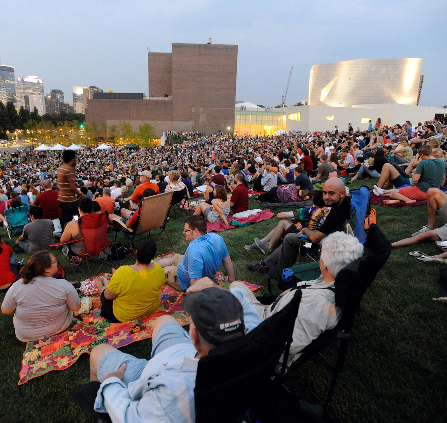 An estimated crowd of 6000 gathered at sundown outside the Walker Art Center for the first "Internet Cat Video Film Festival," showcasing the best of cat films on the Internet in Minneapolis Thursday, Aug. 30, 2012. The Walker Art Center in Minneapolis held its first-ever online cat video festival, a compilation of silly cat clips that have become an Internet phenomenon, attracting millions of viewers for some of the videos. (AP Photo/Craig Lassig) ORG XMIT: MNCL112