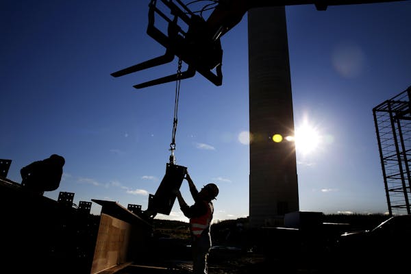 An iron worker in 2014 moves steel on the Essar Steel Minnesota's taconite mine project in Nashwauk, Minn. The company, now named Mesabi Metallic Co.,