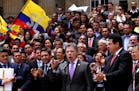 Colombia's President Juan Manuel Santos, front, second from right, speaks after delivering to Congress the peace deal with rebels of the Revolutionary