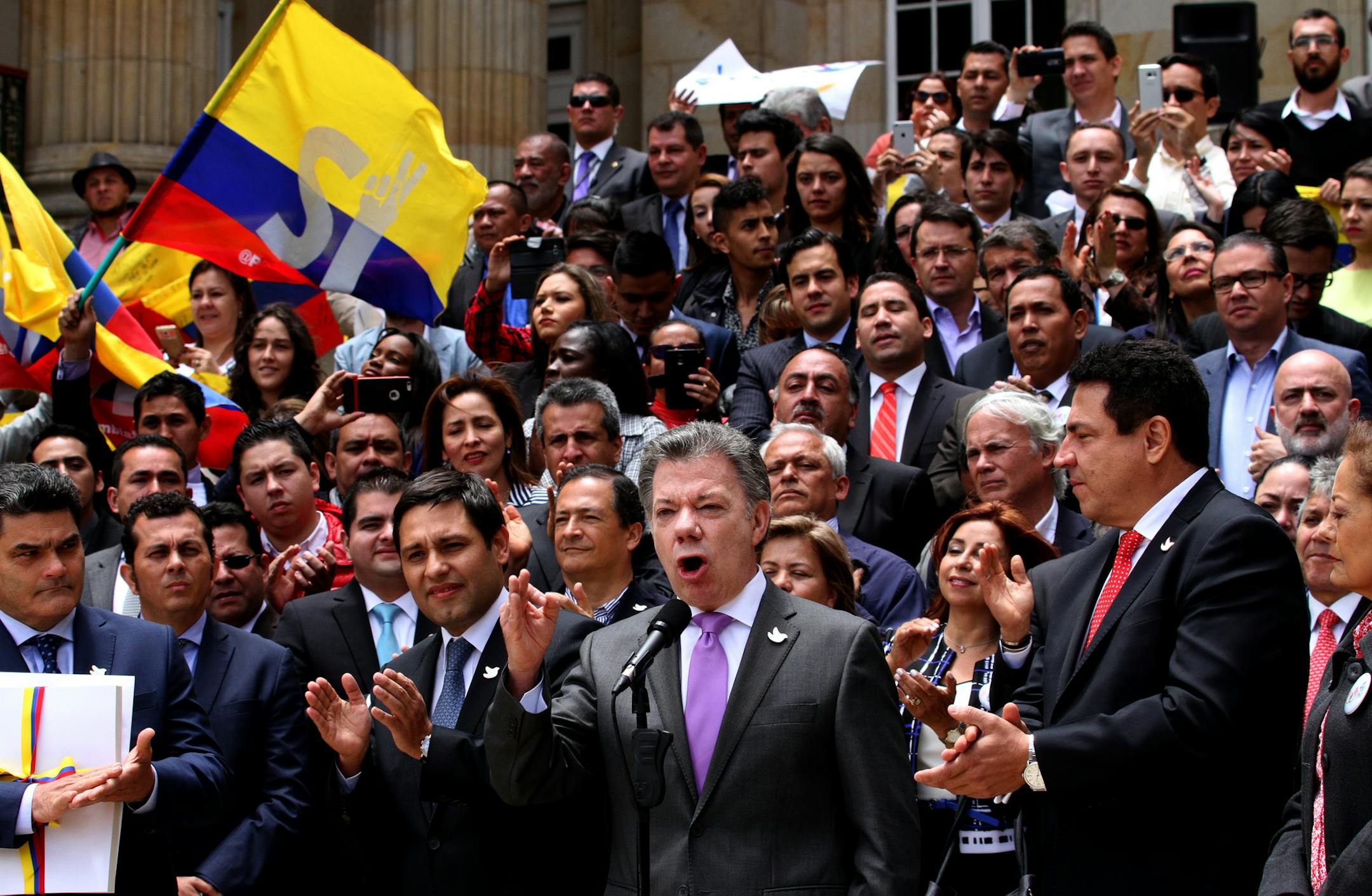 Colombia's President Juan Manuel Santos, front, second from right, speaks after delivering to Congress the peace deal with rebels of the Revolutionary Armed Forces of Colombia, FARC, in Bogota, Colombia, Thursday, Aug. 25, 2016. Santos is moving fast to hold a national referendum on a peace deal meant to end a half-century conflict with leftist rebels, delivering the final text of the deal on Thursday to Congress and declaring a definitive ceasefire against the guerrillas.(AP Photo/Felipe Caiced