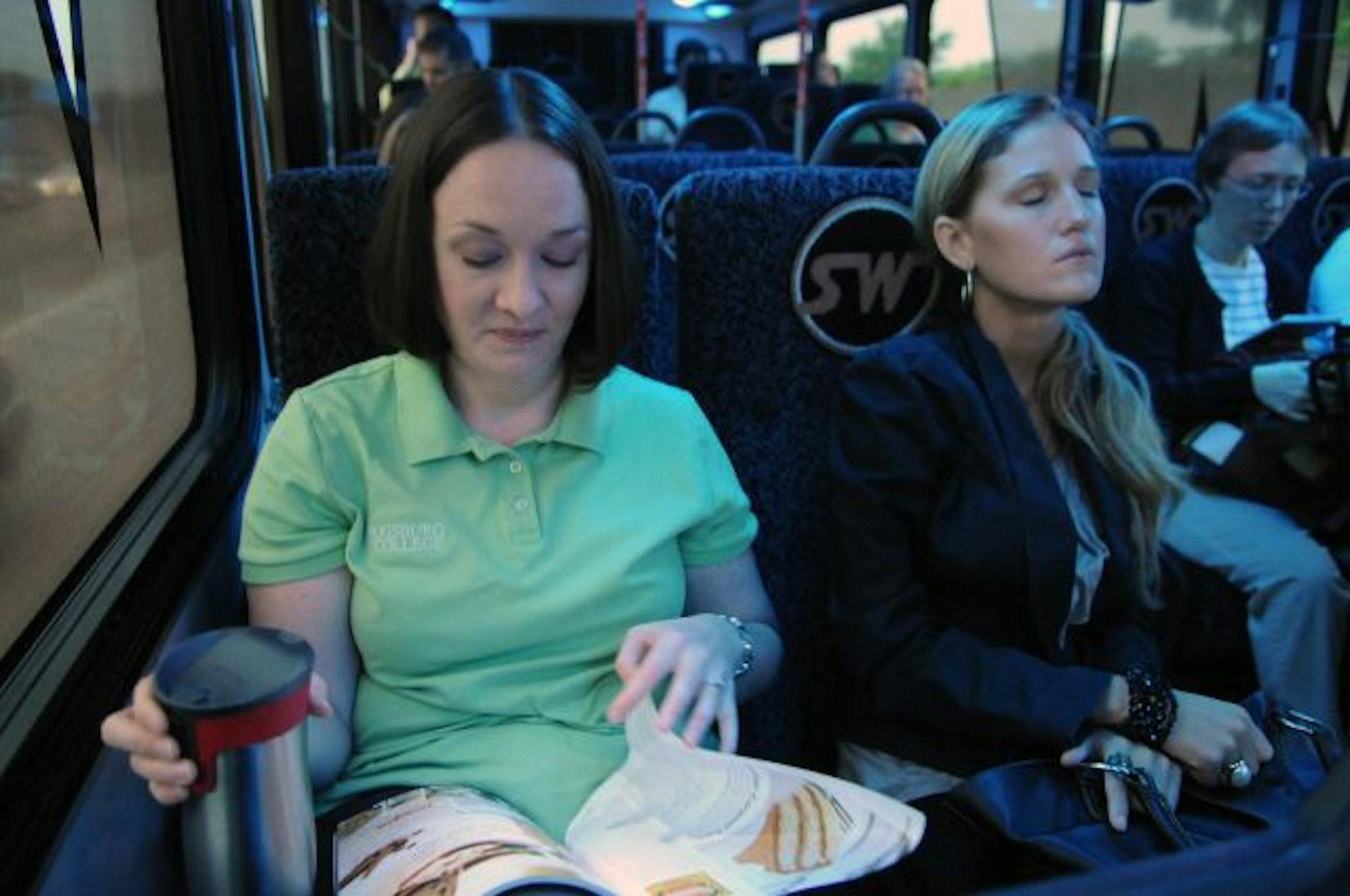 Lori York thumbs through a magazine while riding the bus to Minneapolis.