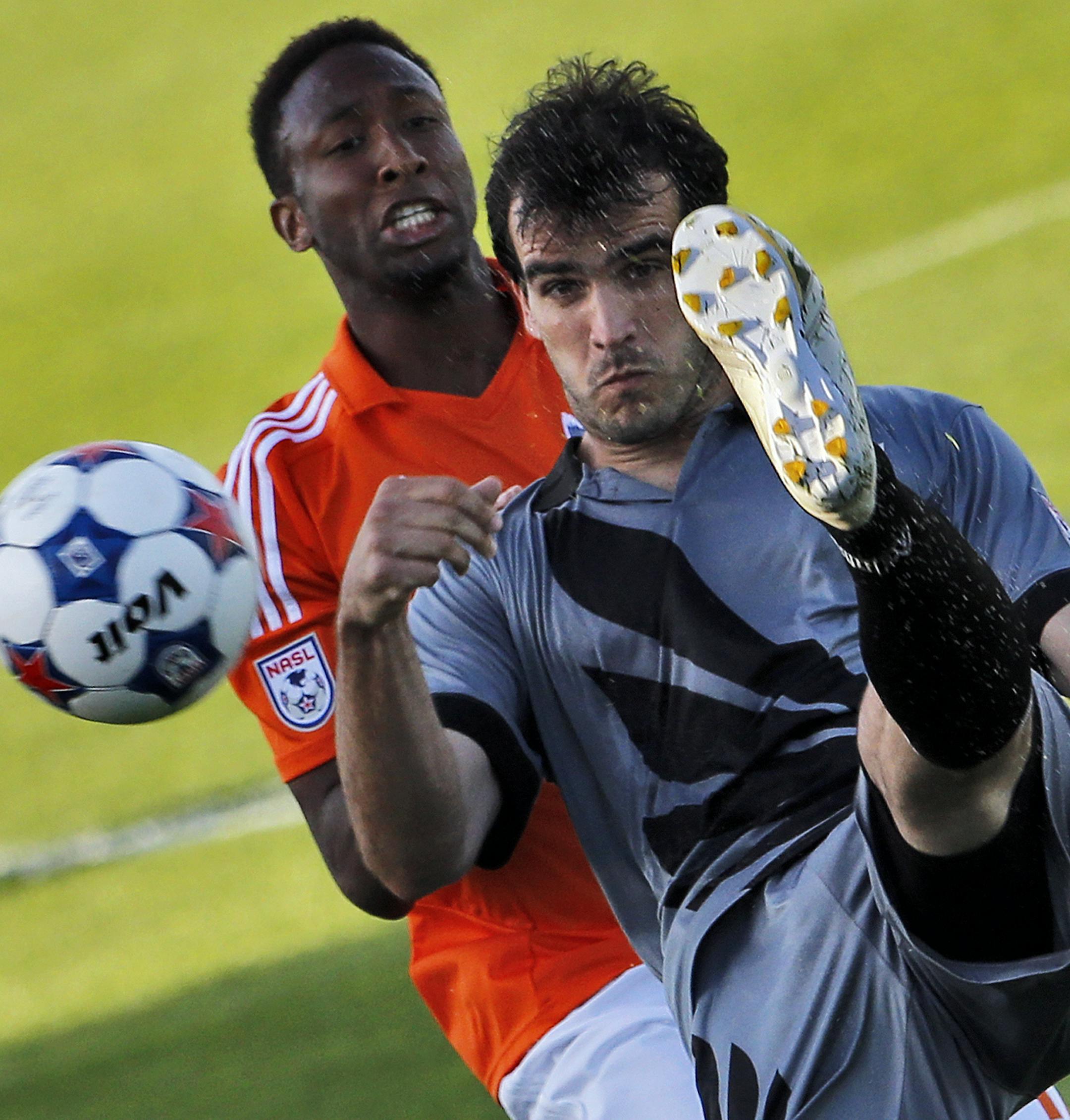 United's Cristiano Dias (foreground) kicked the balla away from Carolina's Daniel Jackson. ] Minnesota United vs. Carolina Railhawks soccer. (MARLIN LEVISON/STARTRIBUNE(mlevison@startribune.com)