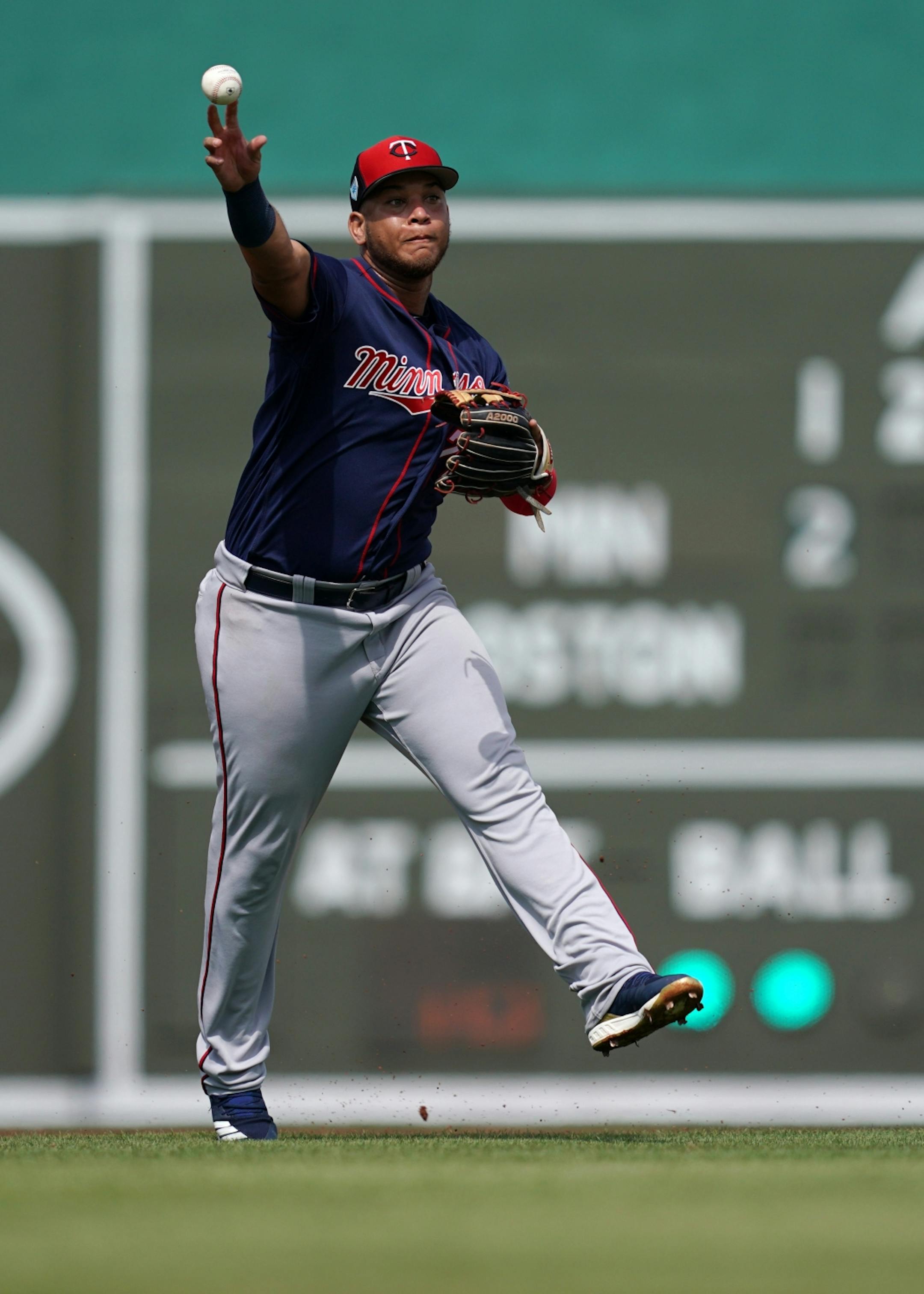 Minnesota Twins third baseman Randy Cesar (72) threw the ball to first to tag out Boston Red Sox left fielder Andrew Benintendi (16) during Sunday's game.