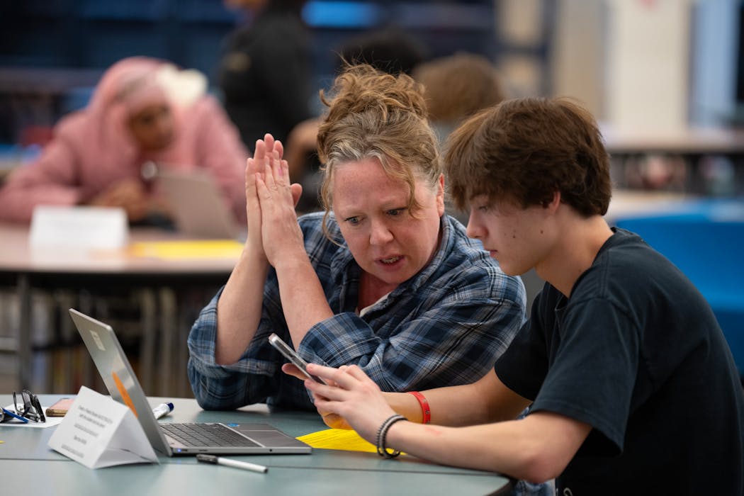 Rachel Hopper and her son, Espen Hopper-Willams, fill out the FAFSA form together on a laptop during the financial aid workshop at South High School in Minneapolis on Feb. 6.
