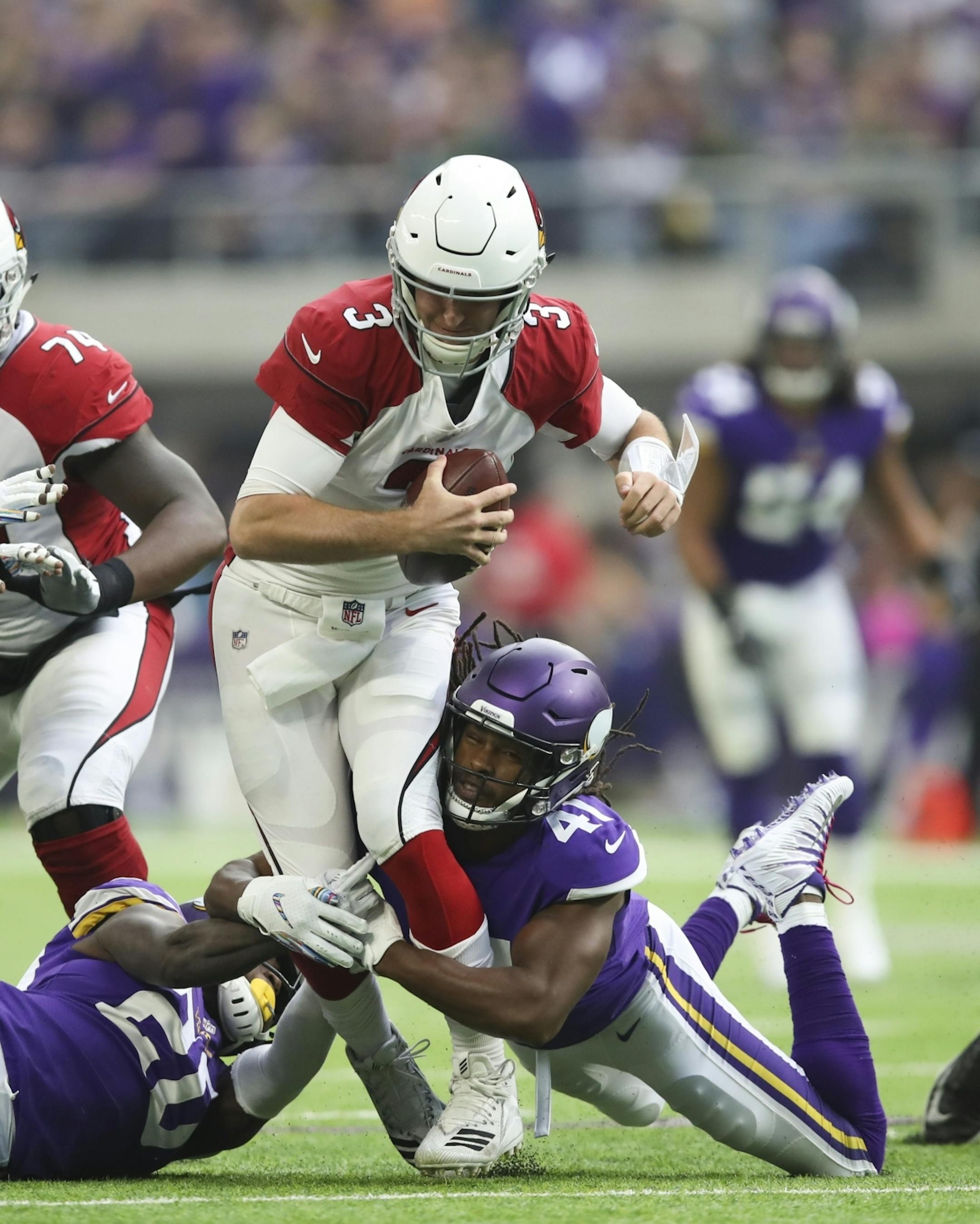 Arizona Cardinals quarterback Josh Rosen (3) was sacked by Vikings cornerback Mackensie Alexander (20) and defensive back Anthony Harris (41) in the second quarter.
