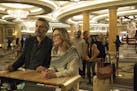 This image released by A24 shows John Torturro and Julianne Moore in a scene from "Gloria Bell." Everyone is vanishing around Julianne Moore's title c