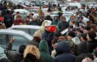 Hundreds of people showed up in 2006 for a St. Paul impound lot car auction. Auctioneer Mark Friederichs is at the center with a red bullhorn.