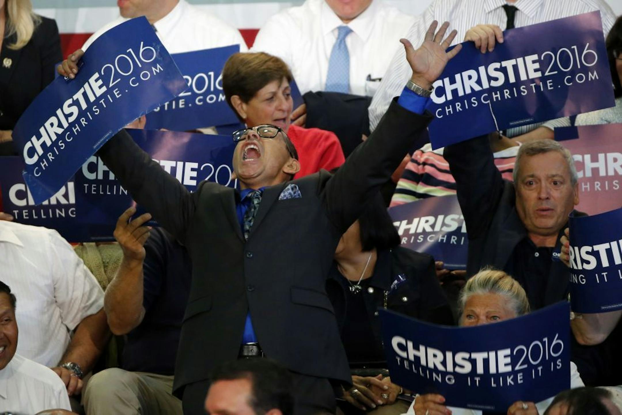 Angel Cordero, an activist from East Camden, N.J., shouts prior to an event in which New Jersey Gov. Chris Christie announced he will seek the Republican nomination for president, Tuesday, June 30, 2015, at Livingston High School in Livingston, N.J.