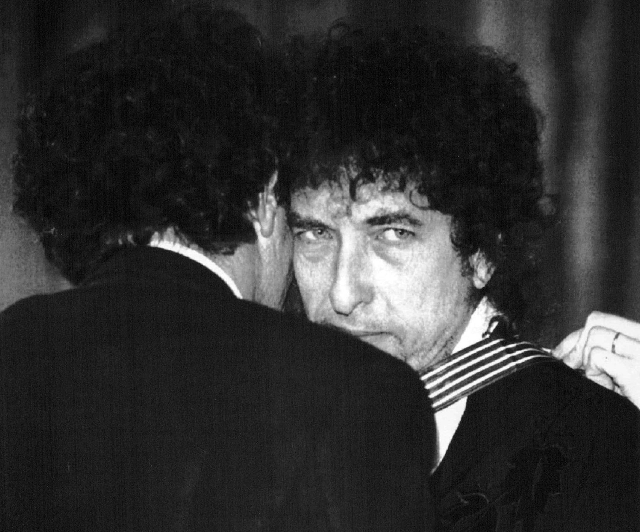 January 30,1990 French culture minister Jack Lang (L) embraces U.S. poet and folk singer Bob Dylan, 49, after awarding him with the commandership for arts and literature.Dylan is in Paris for a series of three concerts. January 31,1990